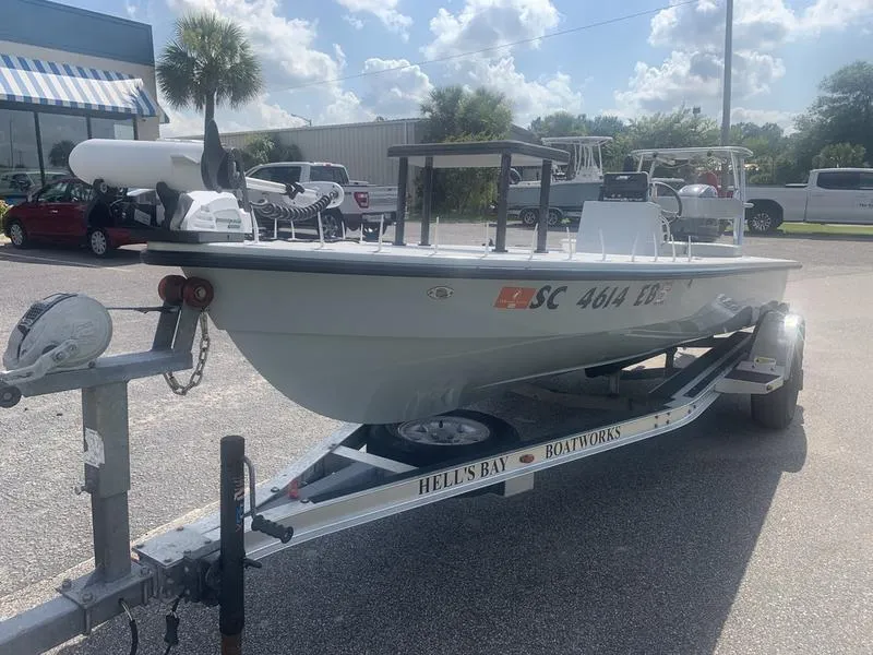 Slide: The Image of 2018 Custom Biscayne boat on trailer, parked outdoors under a sunny sky. - 8