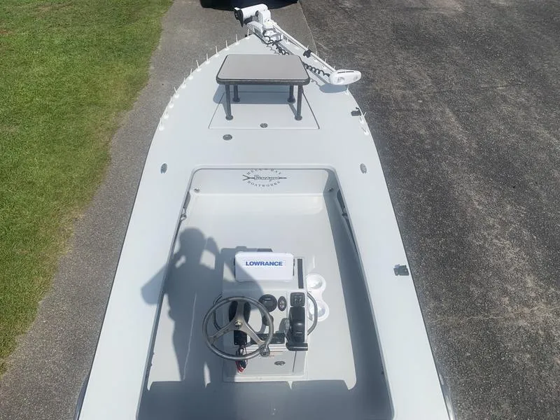 Slide: The Image of 2018 Custom Biscayne boat with Lowrance system, steering wheel, and trolling motor on pavement. - 9