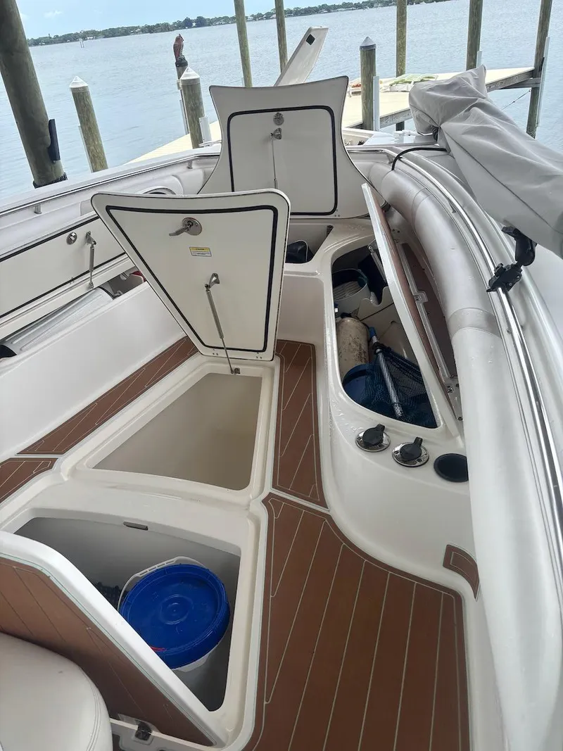 Slide: The Image of 2006 Boston Whaler 320 Outrage boat interior with open storage compartments. - 10