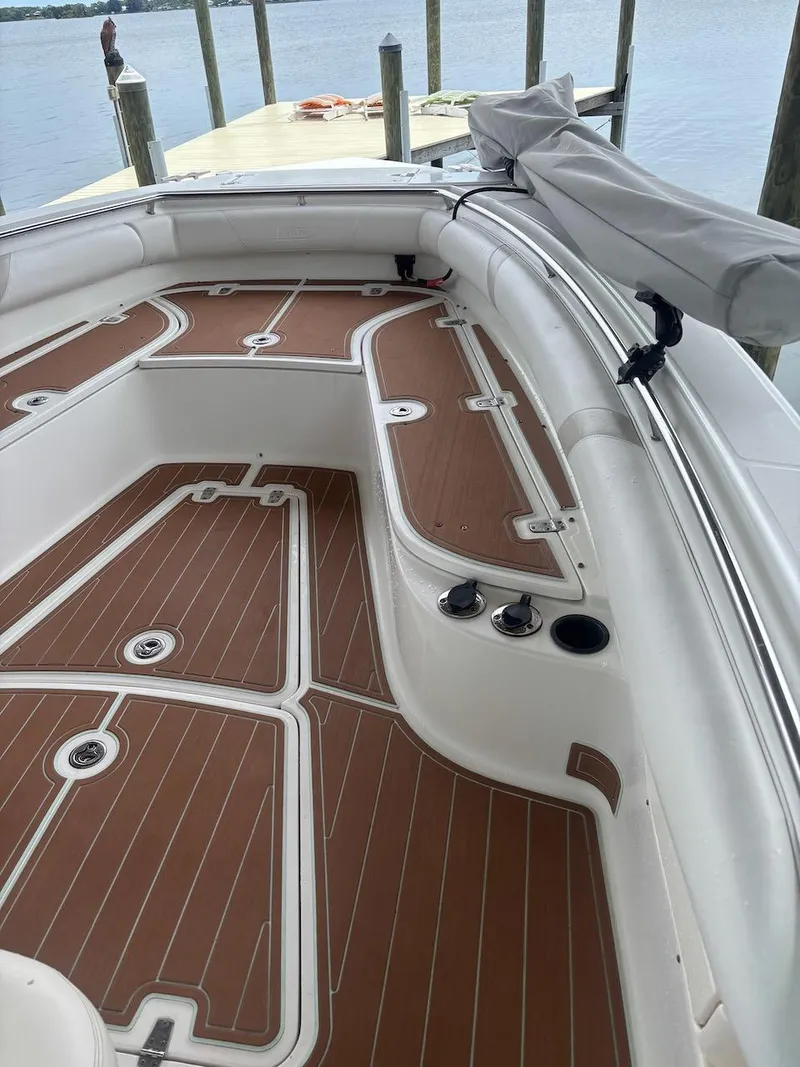 Slide: The Image of 2006 Boston Whaler 320 Outrage boat interior with teak-style flooring at dock. - 11