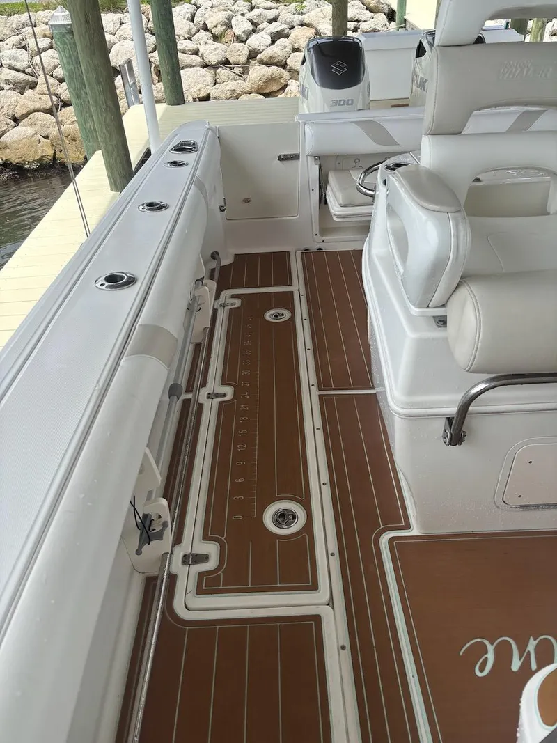 Slide: The Image of 2006 Boston Whaler 320 Outrage boat interior with teak flooring and seating. - 14