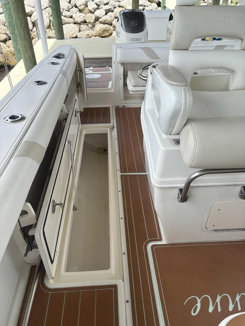 Slide: The Image of 2006 Boston Whaler 320 Outrage interior with open storage compartment and seating. - 15