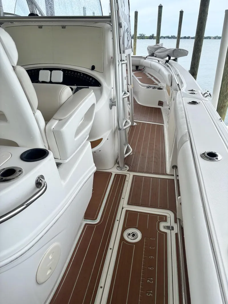 Slide: The Image of 2006 Boston Whaler 320 Outrage boat interior with seating and wooden deck. - 17