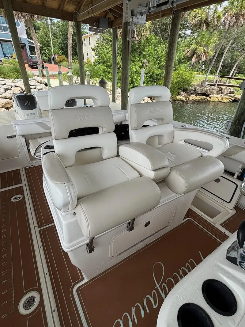 Slide: The Image of 2006 Boston Whaler 320 Outrage boat interior with white seating and brown flooring. - 19
