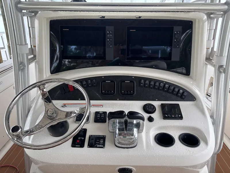 Slide: The Image of Control panel of a 2006 Boston Whaler 320 Outrage boat with steering wheel and electronics. - 24