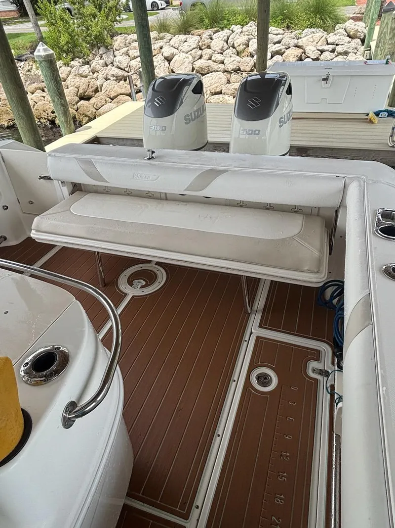 Slide: The Image of 2006 Boston Whaler 320 Outrage boat interior with Suzuki engines and wooden deck. - 26