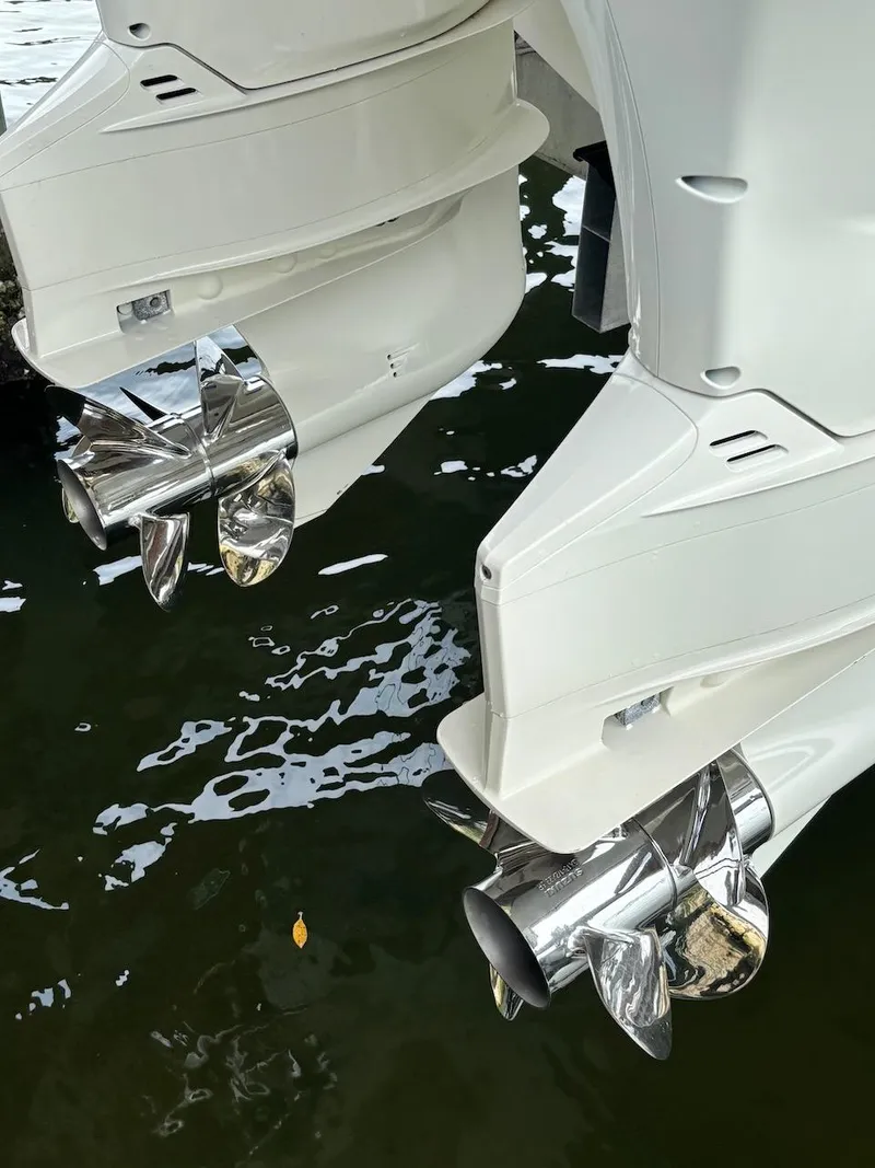 Slide: The Image of Twin outboard motors on a 2006 Boston Whaler 320 Outrage, reflecting in water. - 29