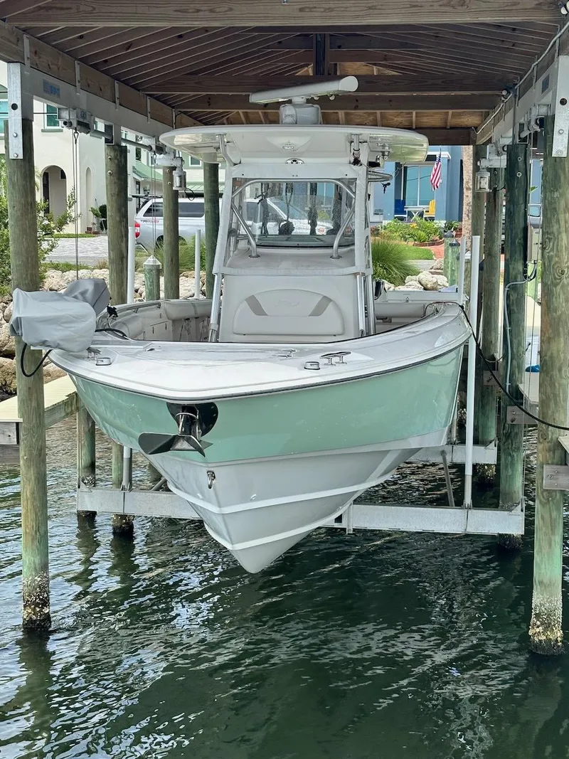 Slide: The Image of 2006 Boston Whaler 320 Outrage boat docked in a covered lift. - 3