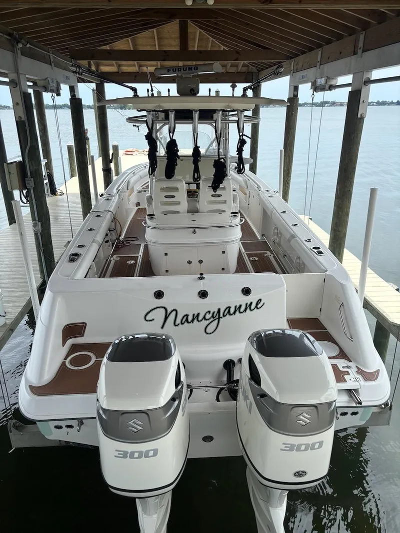 Slide: The Image of 2006 Boston Whaler 320 Outrage boat docked, featuring dual 300 horsepower engines. - 30