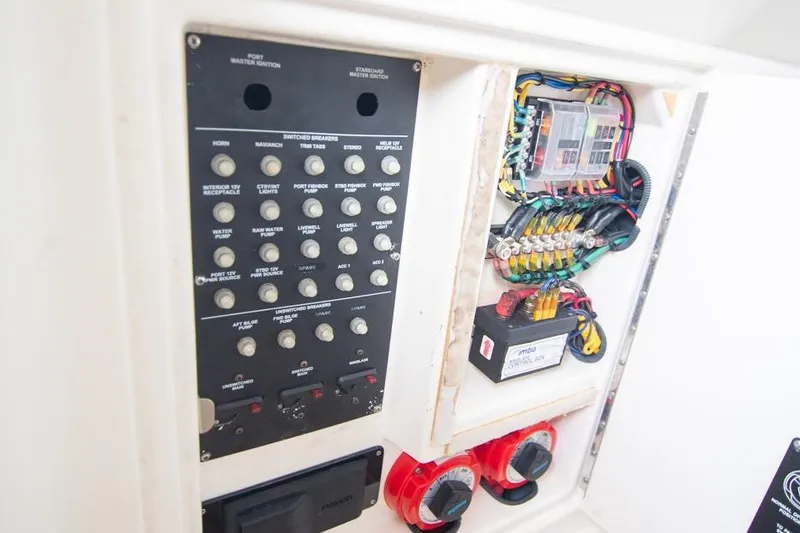 Slide: The Image of Electrical panel of a 2006 Boston Whaler 320 Outrage boat, showing switches and wiring. - 32