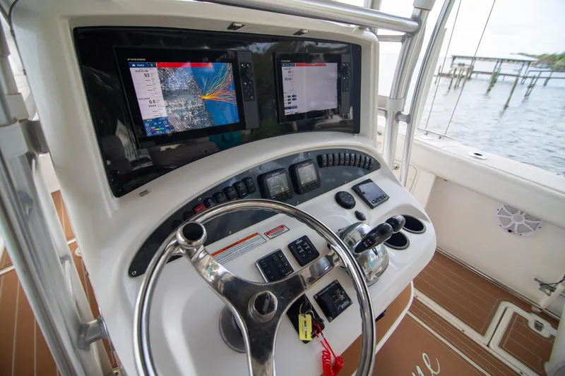 Slide: The Image of 2006 Boston Whaler 320 Outrage helm with navigation screens and controls. - 33