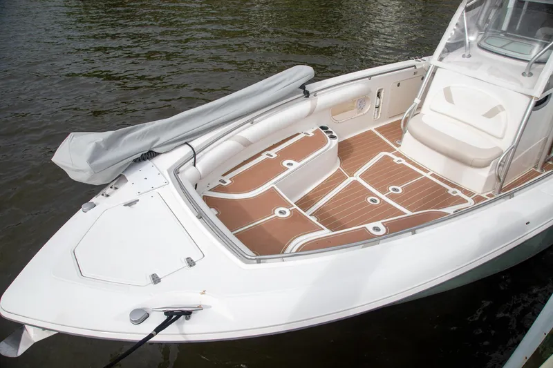 Slide: The Image of 2006 Boston Whaler 320 Outrage boat with spacious deck and seating, docked on water. - 39
