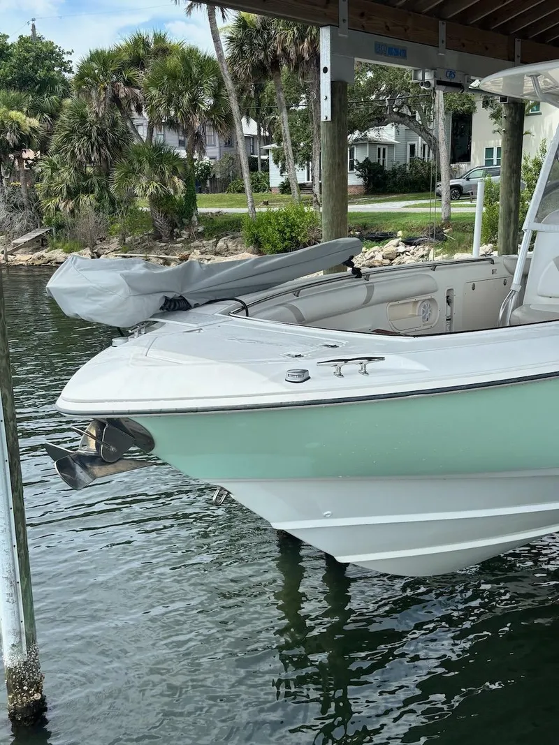 Slide: The Image of 2006 Boston Whaler 320 Outrage boat docked near palm trees and waterfront homes. - 4