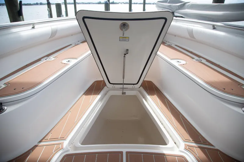 Slide: The Image of 2006 Boston Whaler 320 Outrage boat storage compartment open, showcasing interior space. - 41