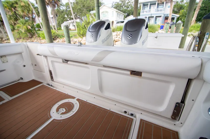 Slide: The Image of 2006 Boston Whaler 320 Outrage boat interior with Suzuki engines, docked near waterfront homes. - 44