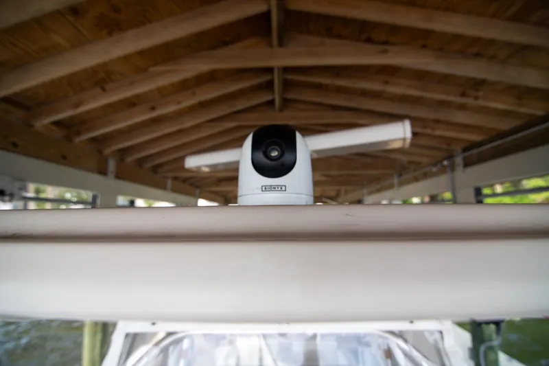 Slide: The Image of 2006 Boston Whaler 320 Outrage radar system under wooden dock roof. - 47