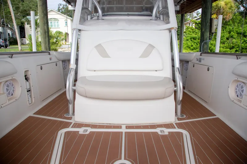 Slide: The Image of 2006 Boston Whaler 320 Outrage interior with cushioned seating and teak-style flooring. - 48