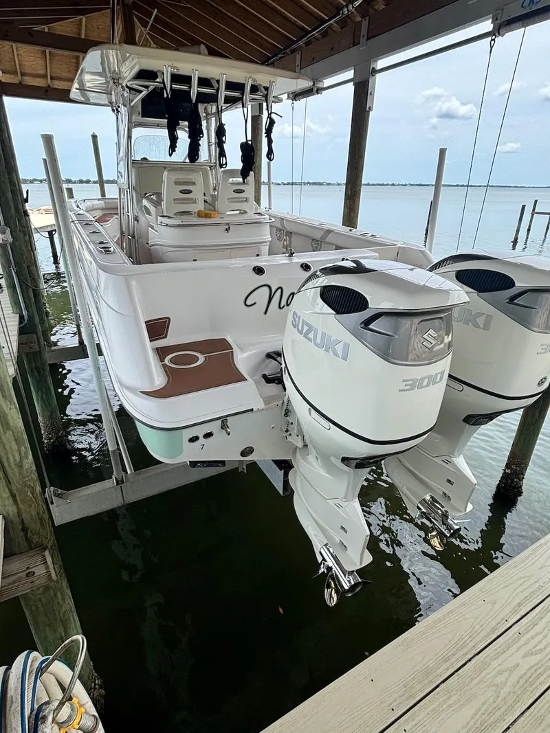 Slide: The Image of 2006 Boston Whaler 320 Outrage with twin Suzuki 300 engines on a boat lift. - 5