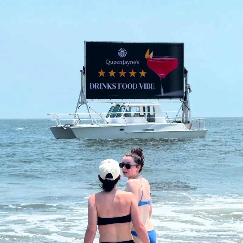 Slide: The Image of Boat with billboard advertising drinks, food, and vibe on the ocean, Searunner Custom Cabin 1996. - 2
