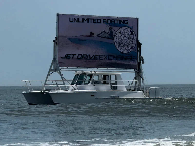 Slide: The Image of Searunner Custom Cabin 1996 boat with large advertising billboard on ocean. - 3