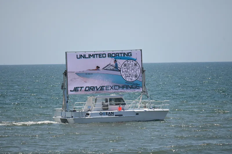 Slide: The Image of Boat with large advertisement on ocean, promoting unlimited boating and jet drive exchange. - 5