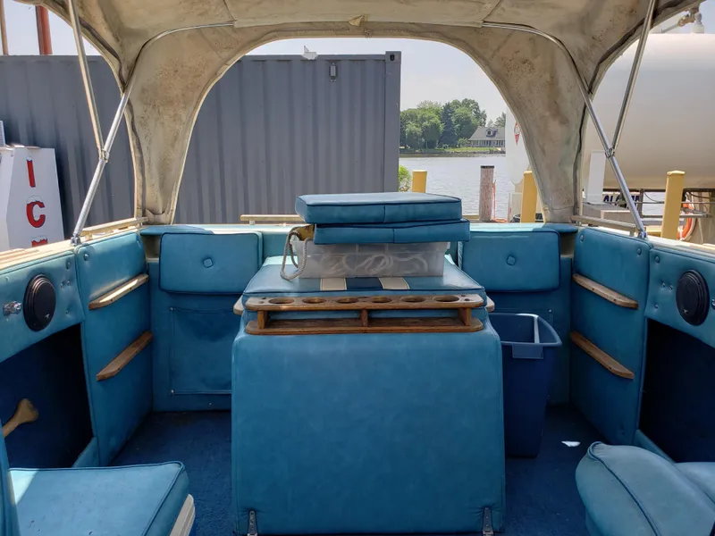 Slide: The Image of 1984 Rinker V205 Cuddy Cabin interior with blue seating and wooden accents. - 9