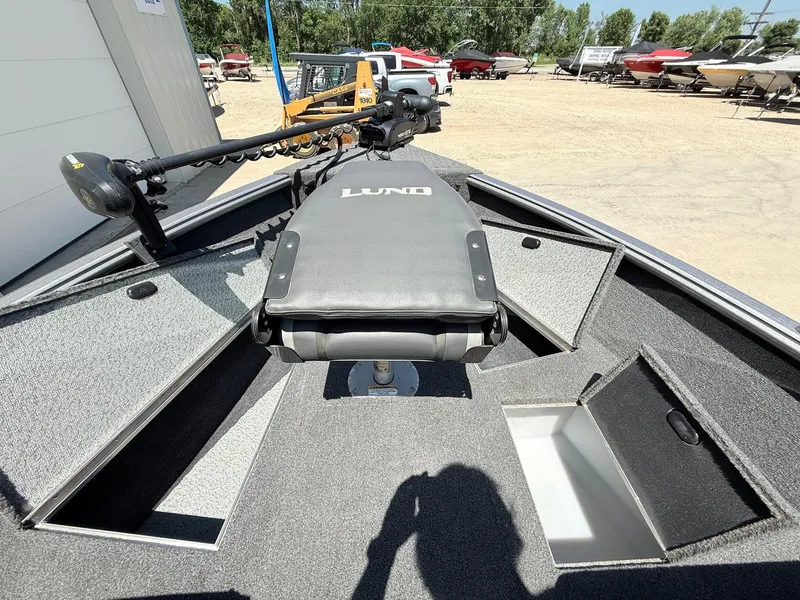 Slide: The Image of 2020 Lund 1775 Impact boat interior with storage compartments and trolling motor. - 12
