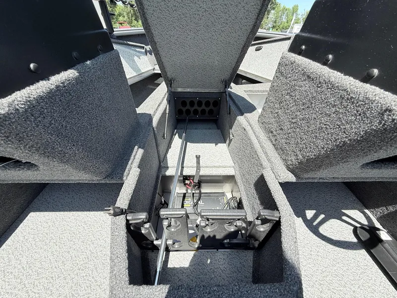 Slide: The Image of 2020 Lund 1775 Impact boat interior storage compartment with open hatch and visible equipment. - 13