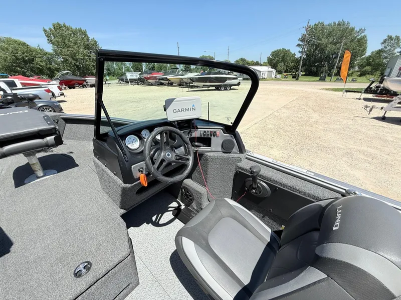 Slide: The Image of 2020 Lund 1775 Impact boat interior with Garmin navigation system and steering wheel. - 16