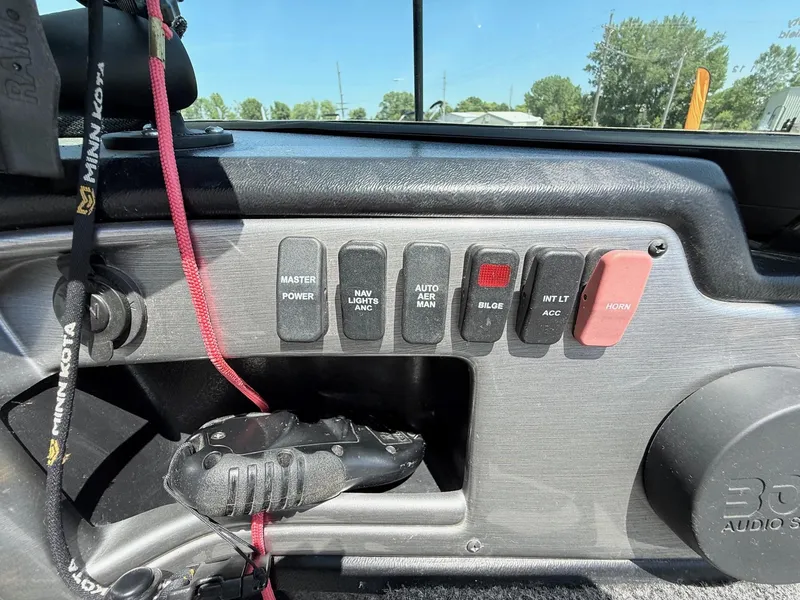 Slide: The Image of Control panel of a 2020 Lund 1775 Impact boat with various switches and accessories. - 18