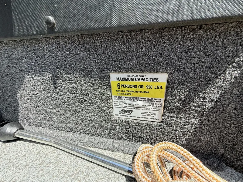Slide: The Image of 2020 Lund 1775 Impact boat capacity label, 6 persons or 950 lbs, with rope and metal pole. - 19
