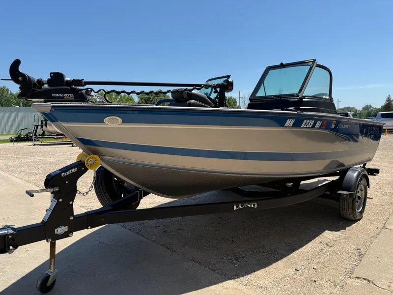 Slide: The Image of 2020 Lund 1775 Impact boat on trailer, featuring Minn Kota trolling motor. - 2