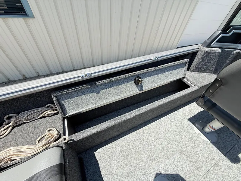 Slide: The Image of 2020 Lund 1775 Impact boat interior with storage compartment and rope. - 23
