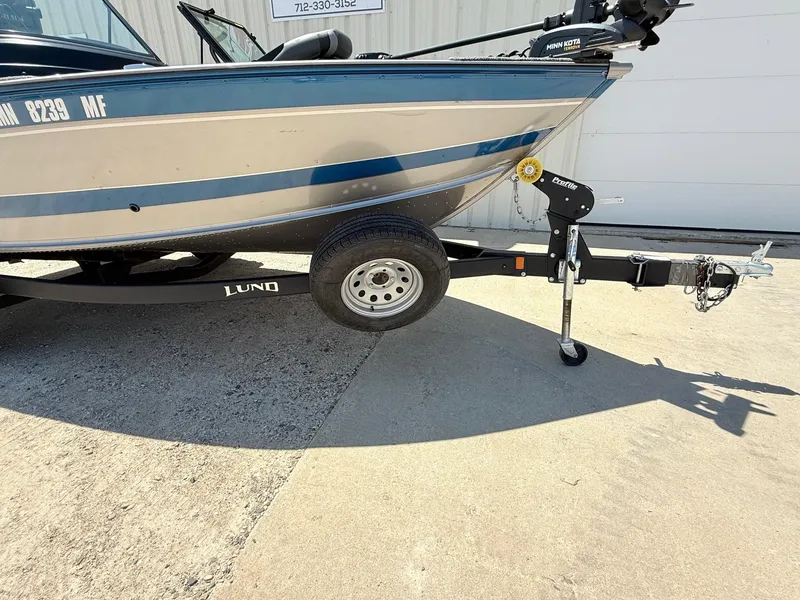 Slide: The Image of 2020 Lund 1775 Impact boat on trailer, parked on concrete surface. - 29