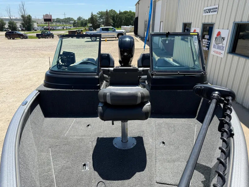 Slide: The Image of 2020 Lund 1775 Impact boat with seating and windshield, parked outside a building. - 3