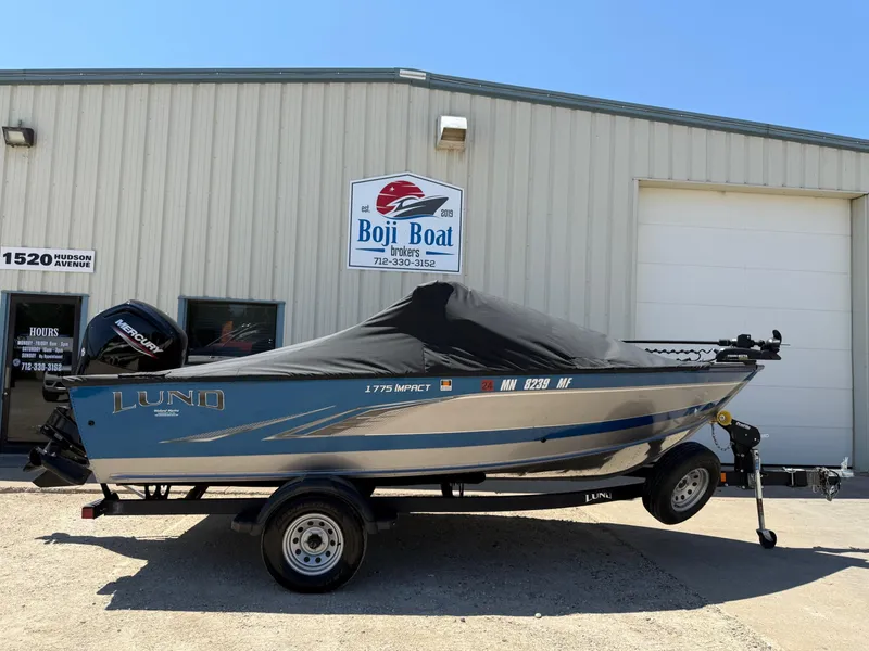 Slide: The Image of 2020 Lund 1775 Impact boat with cover, parked outside Boji Boat Brokers building. - 30
