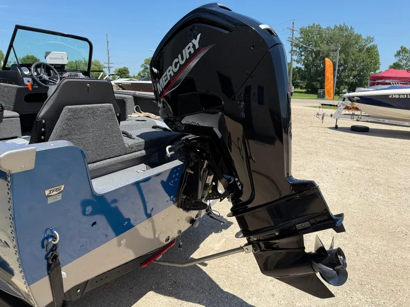 Slide: The Image of 2020 Lund 1775 Impact boat with Mercury outboard motor, parked outdoors. - 4