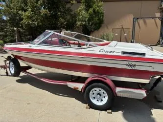 Slide: The Image of 1993 Corona Bowrider boat on trailer, red and white design, parked outdoors. - 3