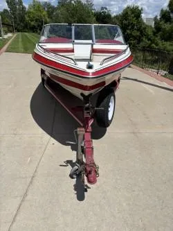 Slide: The Image of 1993 Corona Bowrider boat on trailer, parked on a sunny driveway. - 4