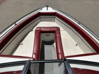 Slide: The Image of 1993 Corona Bowrider boat interior with red and white seating, viewed from above. - 5