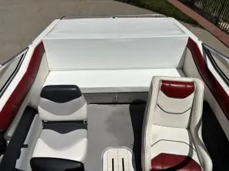 Slide: The Image of 1993 Corona Bowrider boat interior with red and white seating. - 6