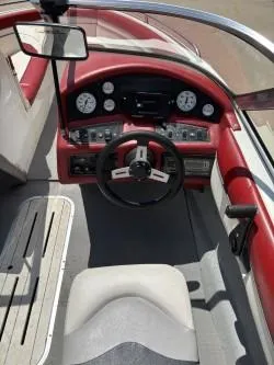 Slide: The Image of 1993 Corona Bowrider boat interior with red dashboard and steering wheel. - 7
