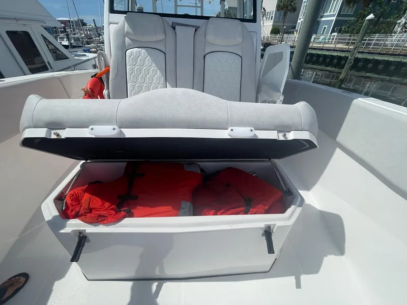 Slide: The Image of 2022 Sea Fox 368 Commander boat with open storage compartment containing life jackets. - 12
