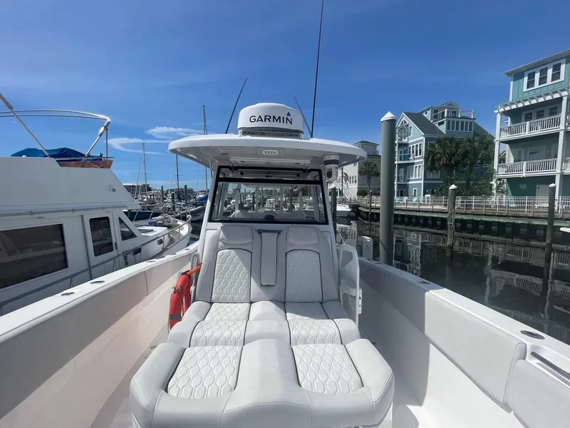 Slide: The Image of 2022 Sea Fox 368 Commander boat docked at marina with modern seating and Garmin equipment. - 13