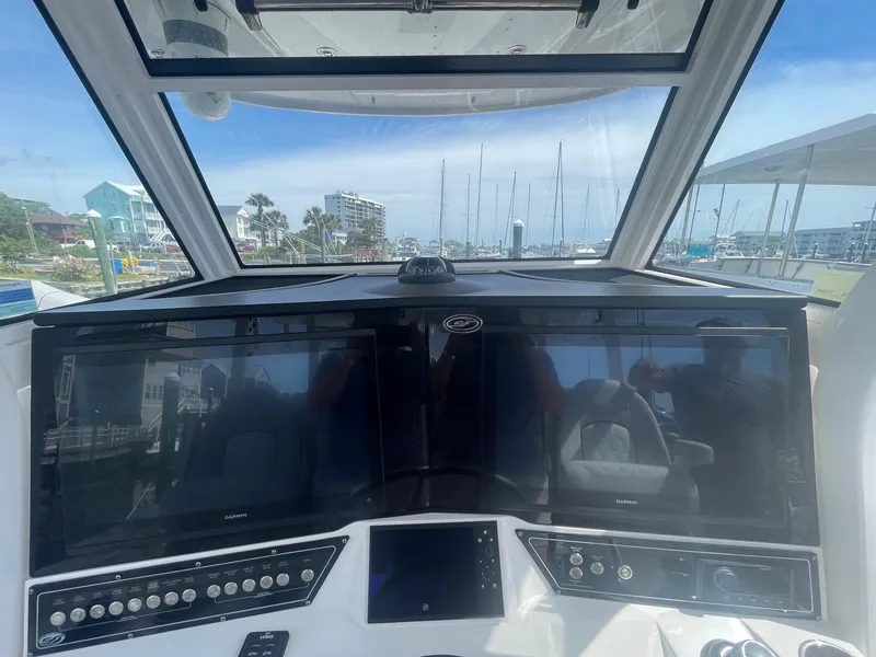 Slide: The Image of 2022 Sea Fox 368 Commander helm with dual Garmin displays and marina view. - 21