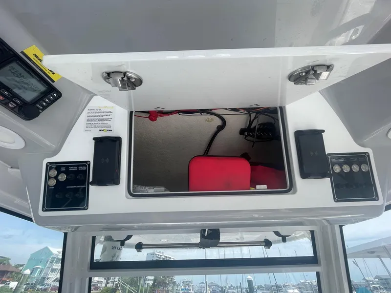 Slide: The Image of Control panel of a 2022 Sea Fox 368 Commander boat with open storage compartment. - 23