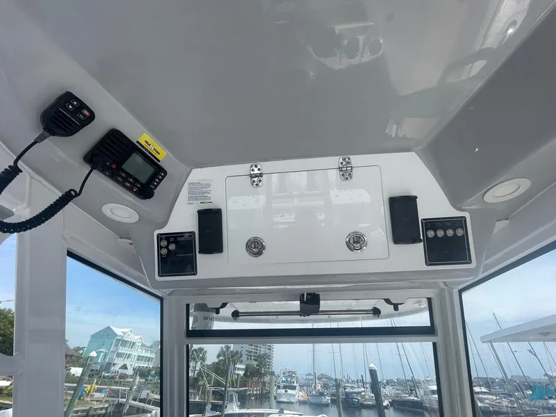 Slide: The Image of Interior view of 2022 Sea Fox 368 Commander boat with control panel and marina background. - 24