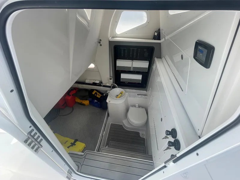 Slide: The Image of Interior of 2022 Sea Fox 368 Commander boat, featuring a compact bathroom and storage area. - 27