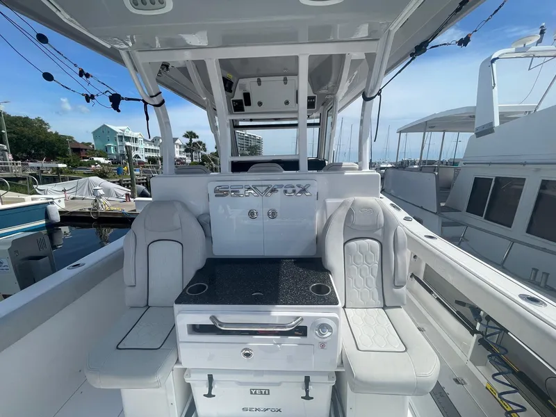 Slide: The Image of 2022 Sea Fox 368 Commander boat interior with seating and console at marina. - 35