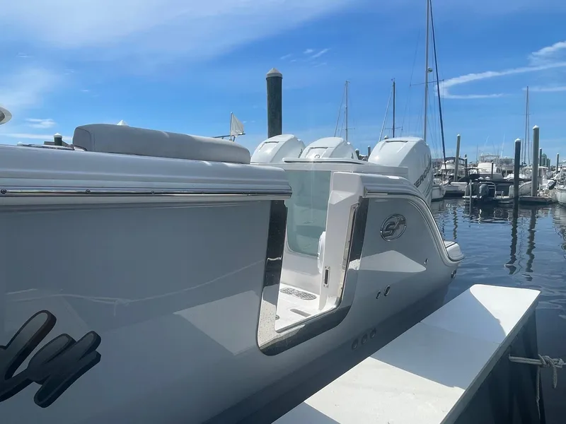 Slide: The Image of 2022 Sea Fox 368 Commander boat docked at marina under clear blue sky. - 36
